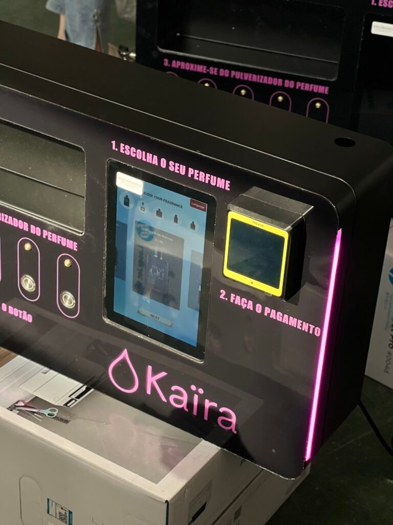 Nayax card reader installed on a perfume vending machine
